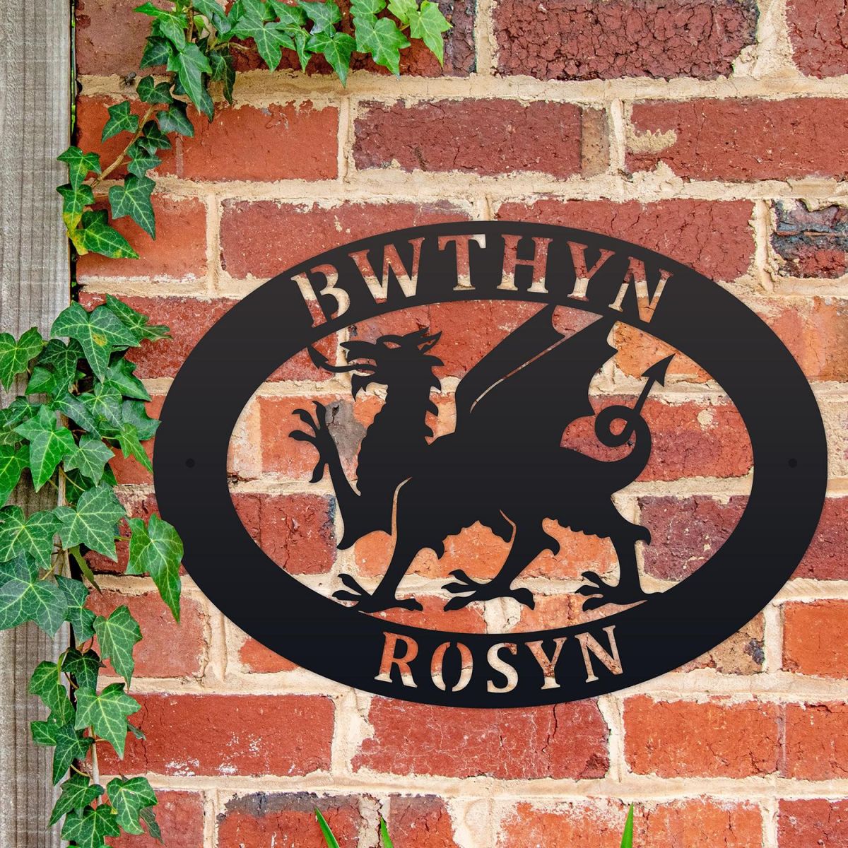 Welsh Dragon Iron Oval House Sign on a Brick Wall