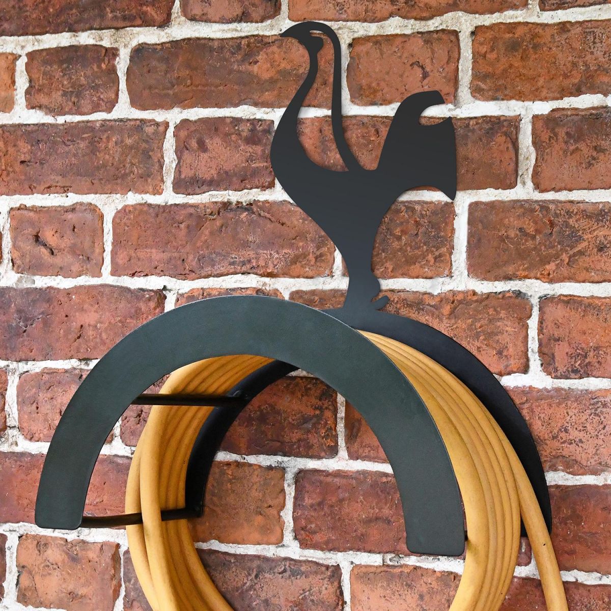 Wall Mounted Contemporary Cockerel Iron Hose Holder Mounted to a Brick Wall