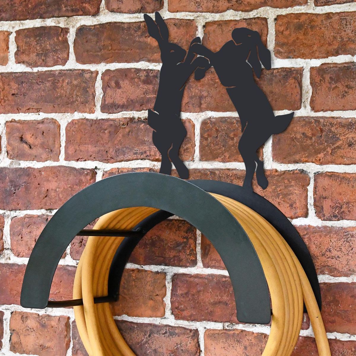 Wall Mounted Boxing Hares Iron Hose Holder Mounted to a Brick Wall Wall Mounted Boxing Hares Iron Hose Holder Mounted to a Brick Wall