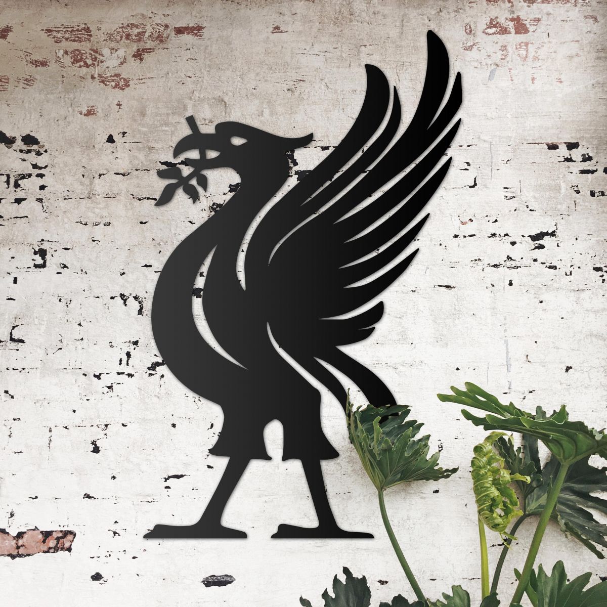 Liver Bird Wall Art on the Wall Next to Plants on a Rustic Wall
