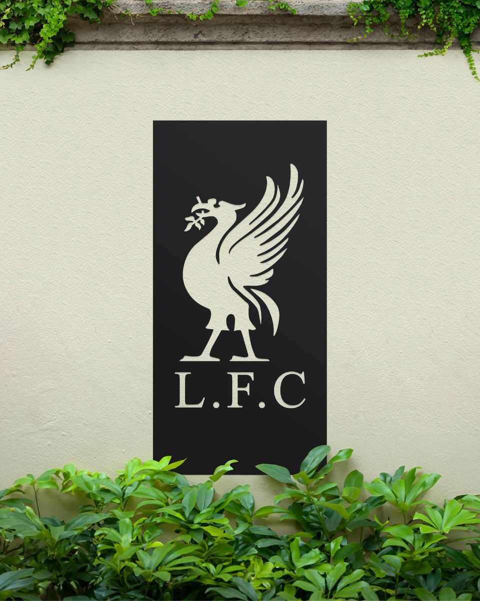 Black "Liver Bird Wall Art" on a cream garden wall surrounded by garden plants Black "Liver Bird Wall Art" on a cream garden wall surrounded by garden plants