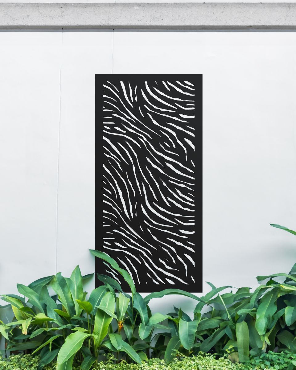 "Black Zebra Print Garden Wall Art" on a white garden wall amongst garden plants