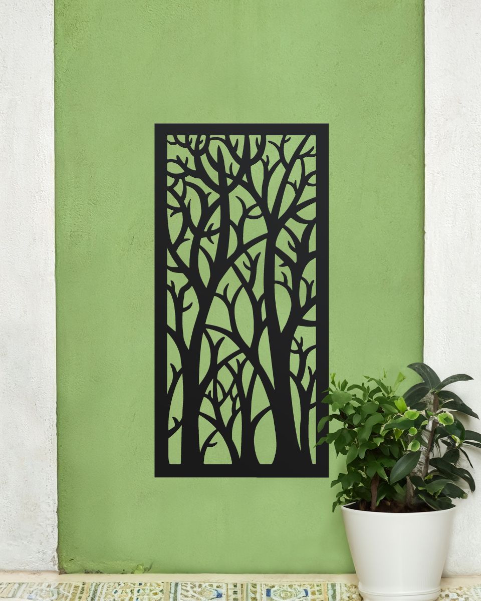 "Black Autumnal Trees Garden Wall Screen" mounted on a green wall next to a plant 