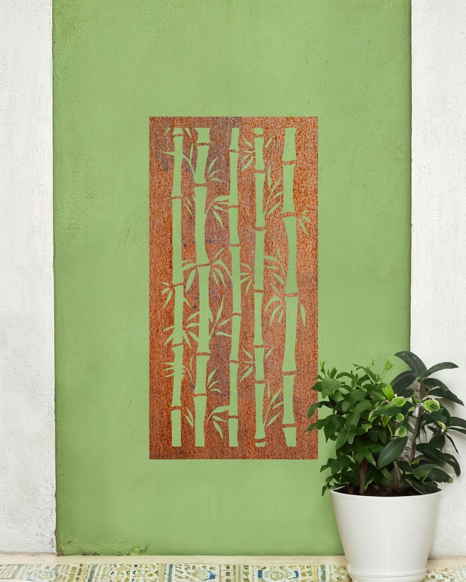 Rust Finish "Bamboo Garden Wall Art" on a green garden wall next to a potted plant 
