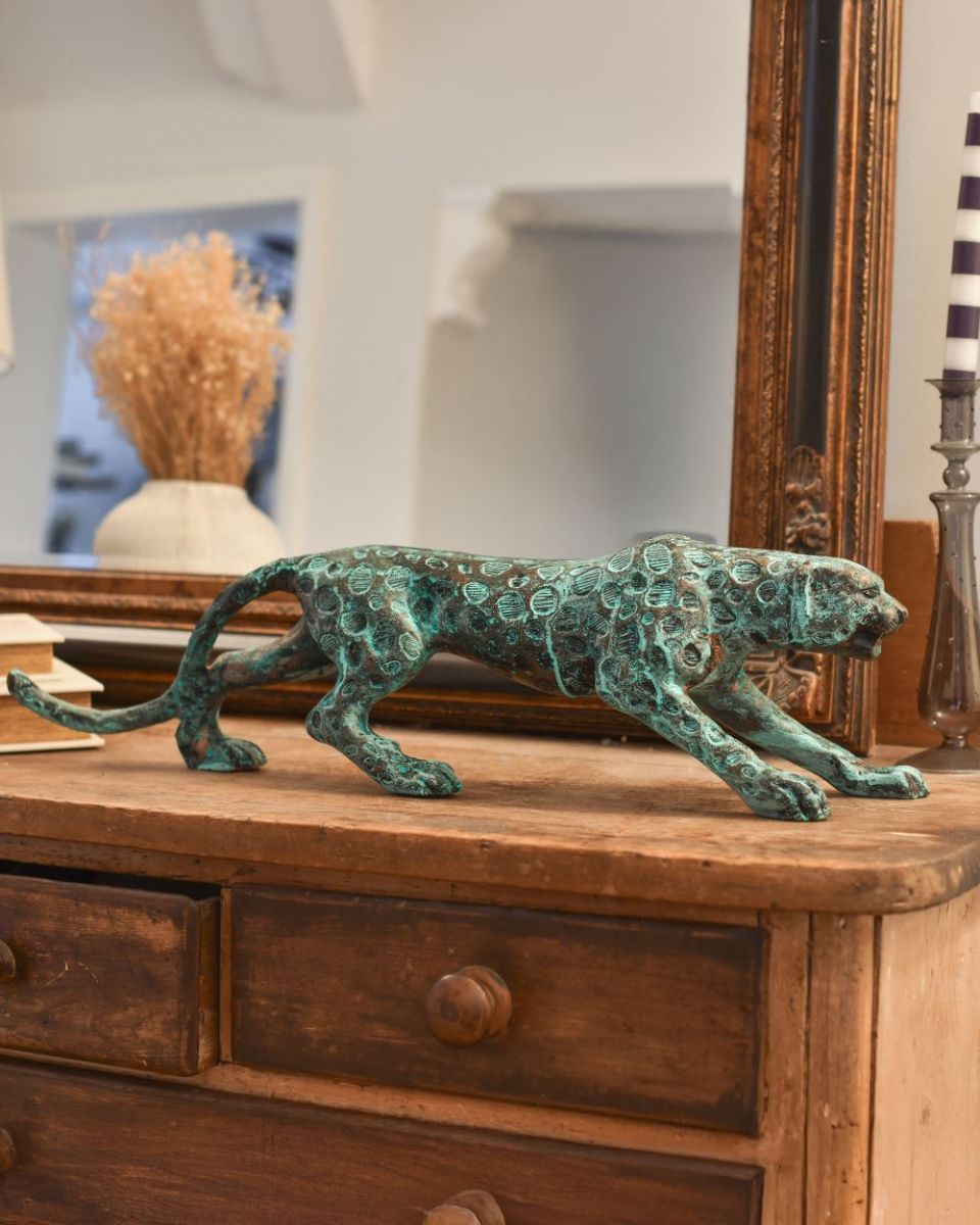 Side view of verdigris leopard sculpture
