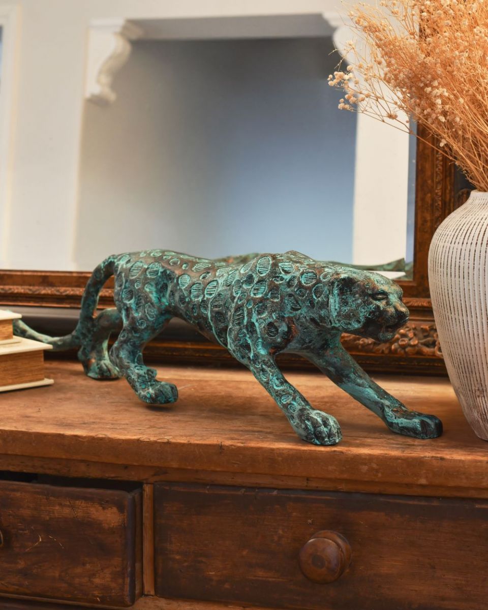 Three quarter view of verdigris leopard sculpture