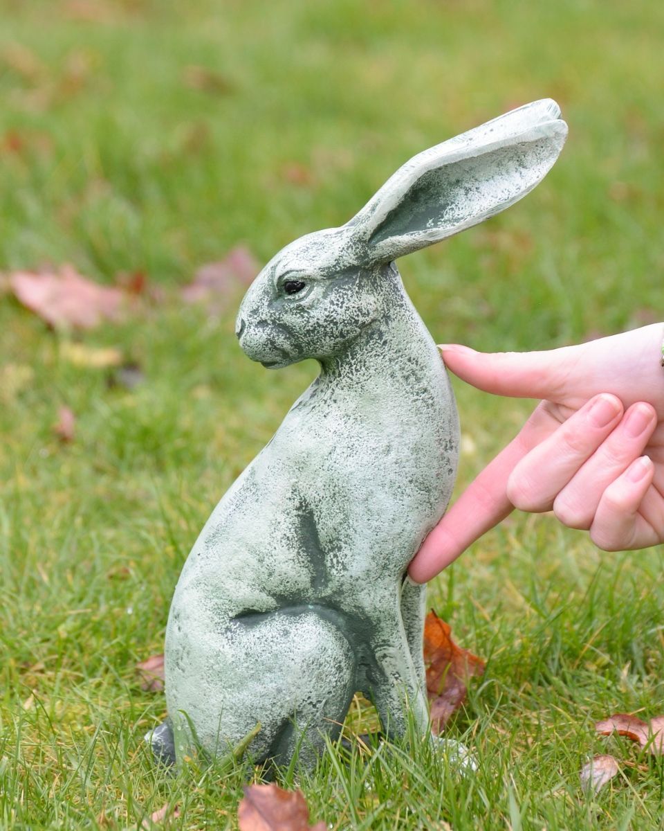 Verdant Watchers Pair of Sitting Rabbit Garden Sculpture Cast Aluminium - ears down sculpture on their own with hand in shot for scale