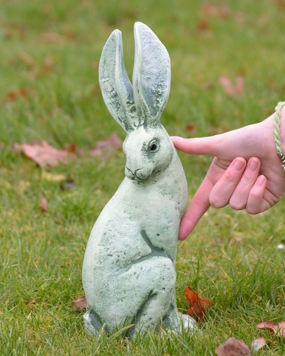 Verdant Watchers Pair of Sitting Rabbit Garden Sculpture Cast Aluminium - ears up sculpture on their own with hand in shot for scale
