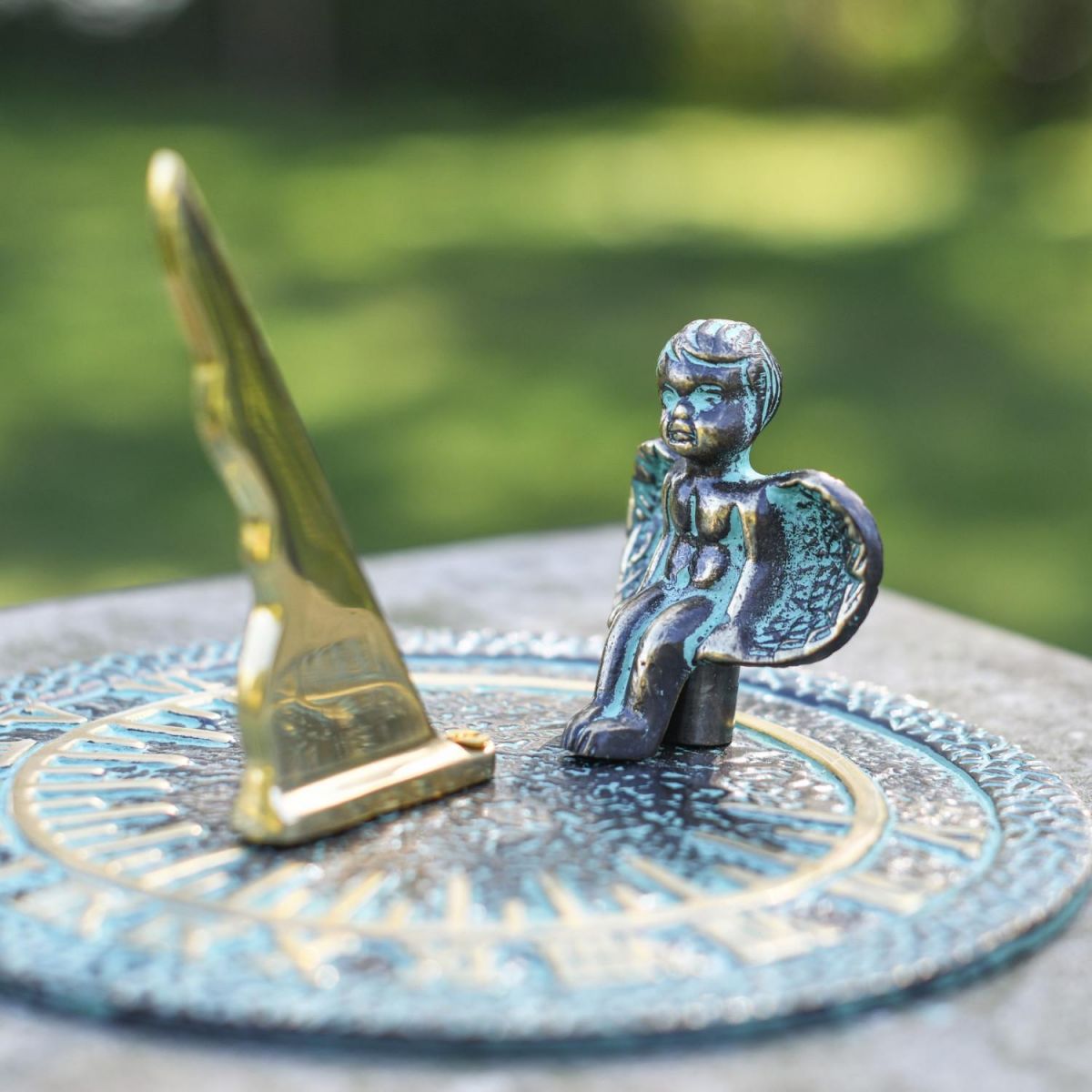 Close-Up of Polished Brass Gnomon on Verdigris Sundial Close-Up of Polished Brass Gnomon on Verdigris Sundial