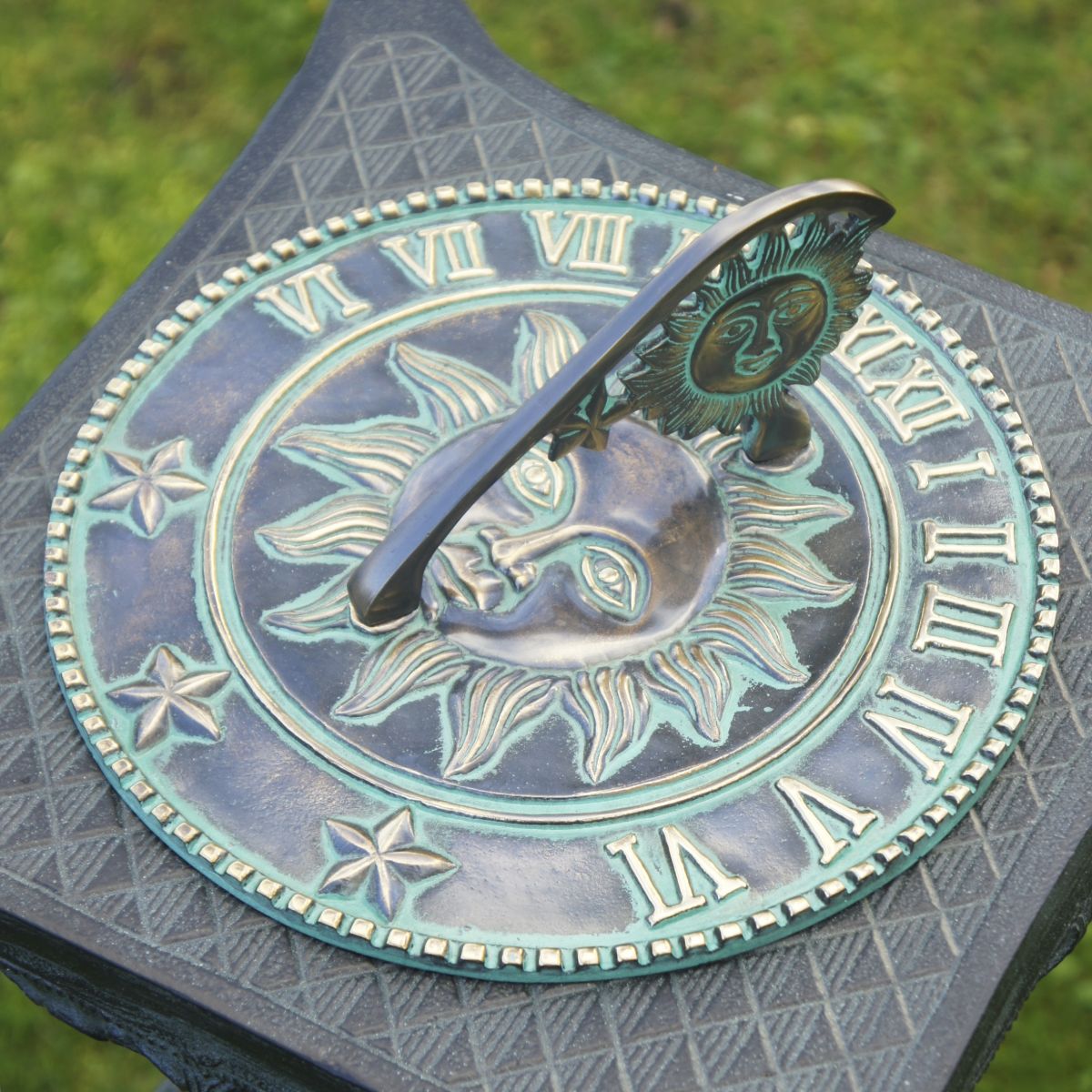 Verdigris garden sundial on plinth
