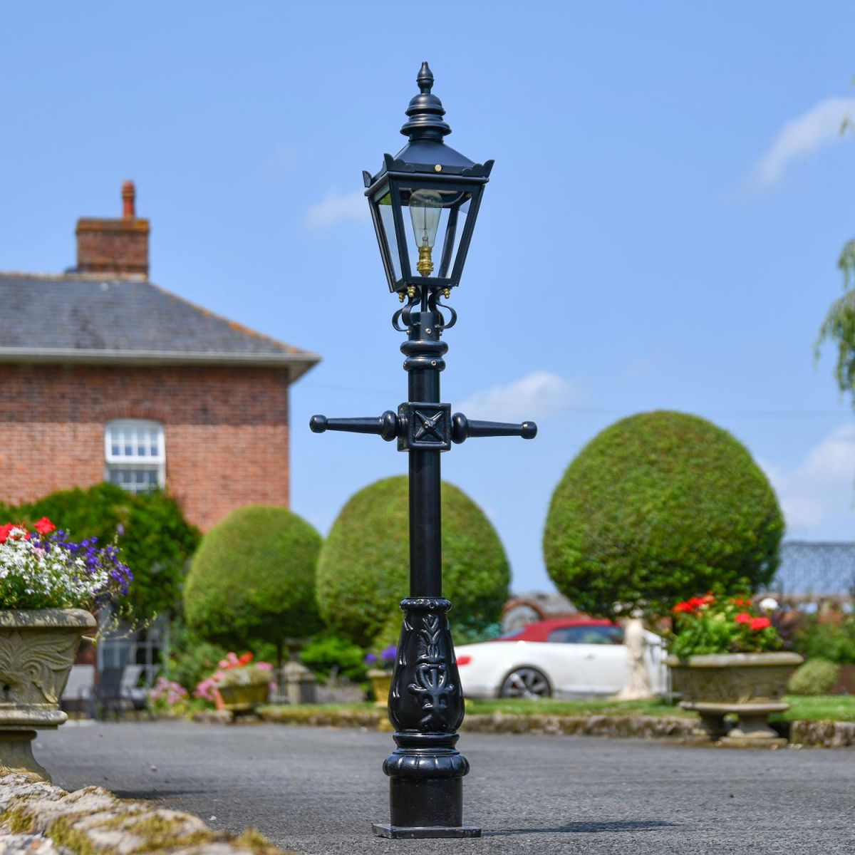 Miniature Victorian Lamp Post in Use on a Driveway in Front of a House
