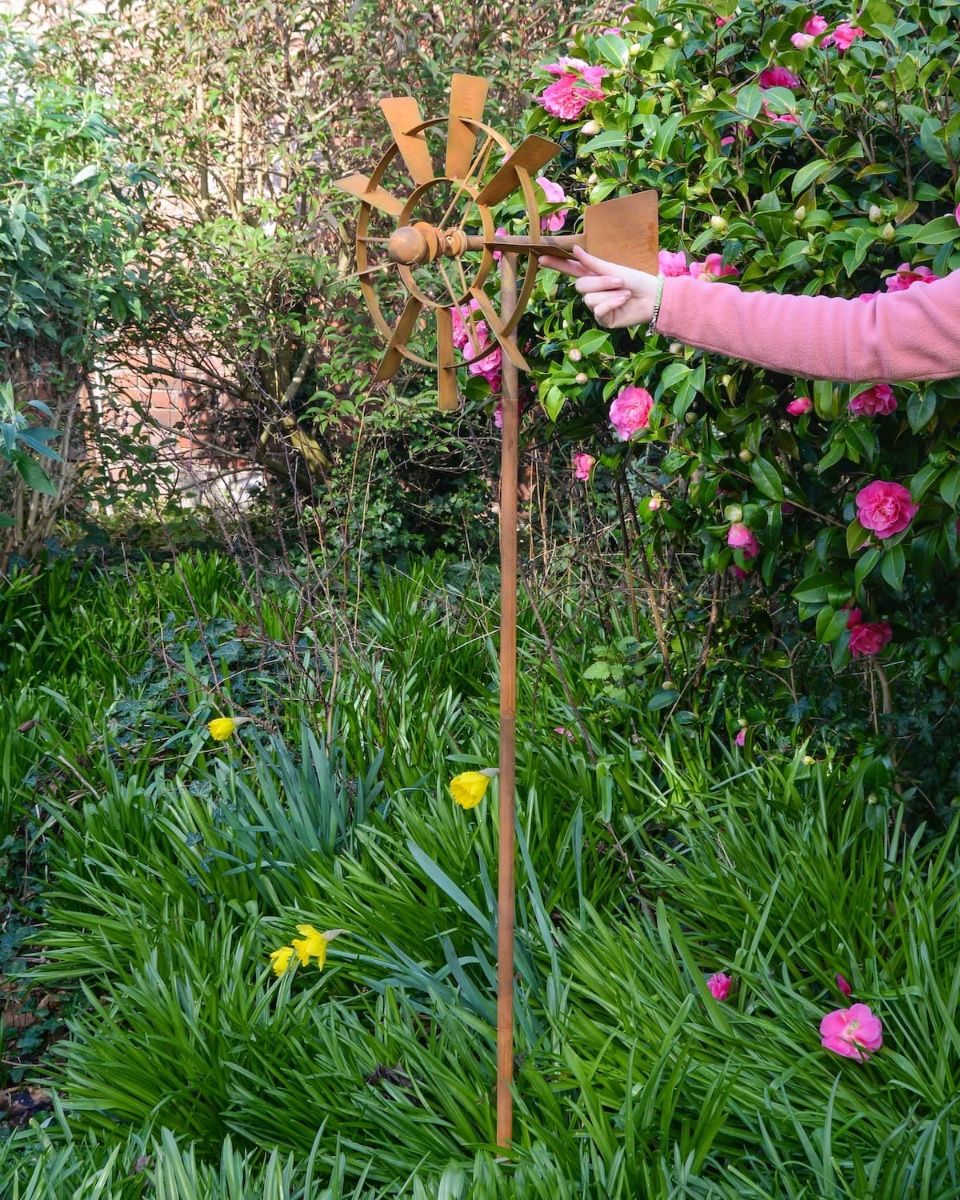 Vintage Farmhouse Garden Wind Spinner with Hand in Shot for Scale