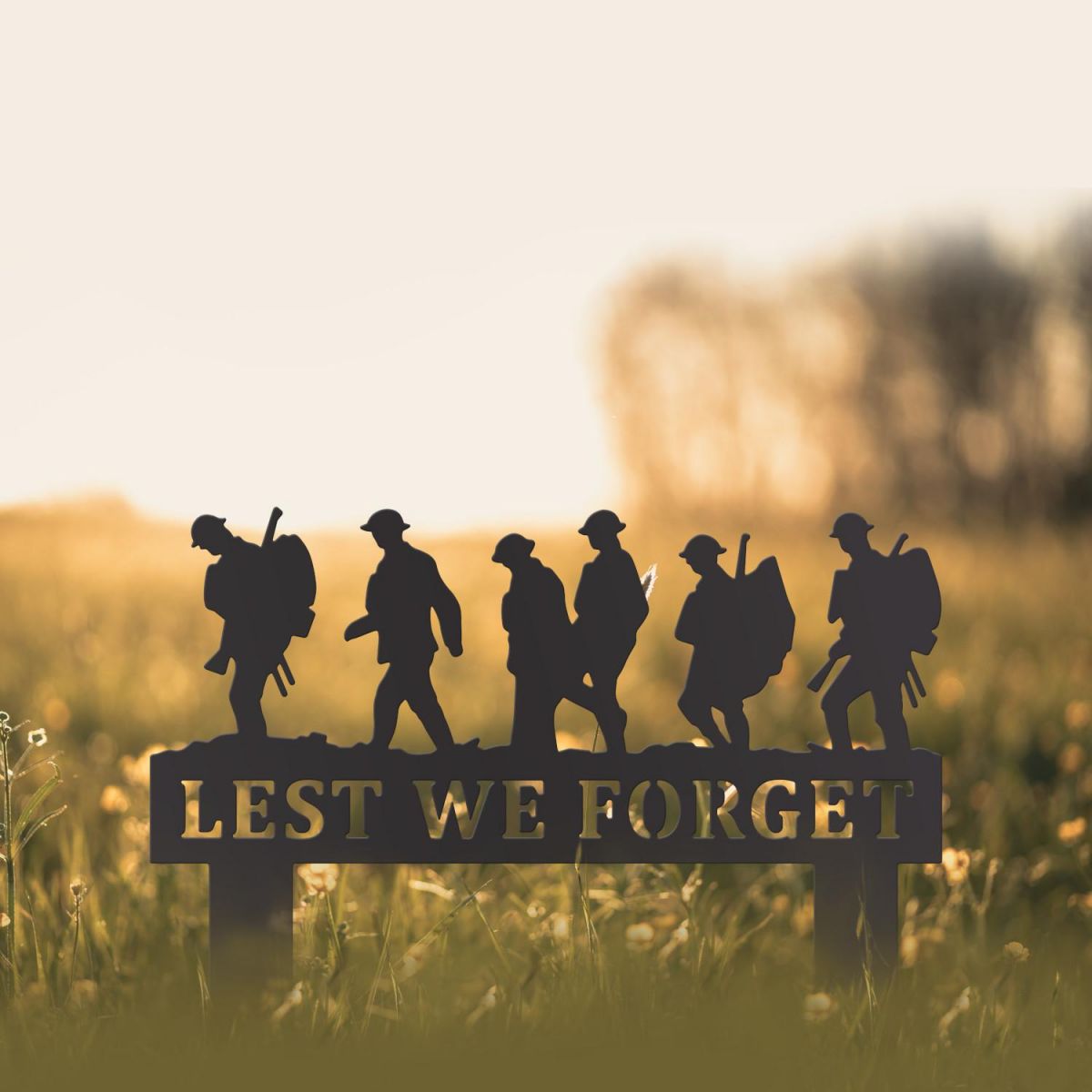 Black Memorial Ground Spike with Walking Soldiers "Lest We Forget" Motif