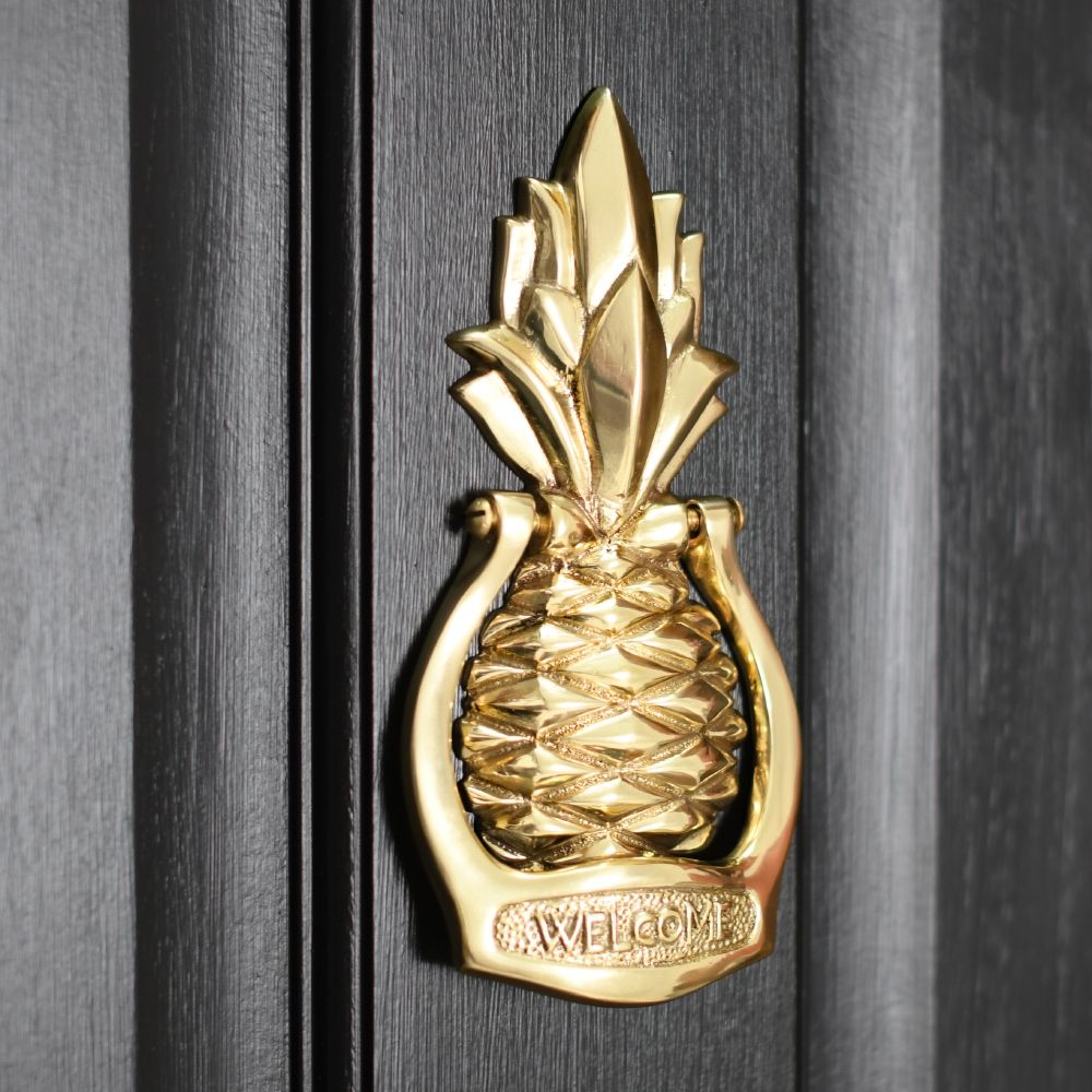 Pineapple door knocker on a black door