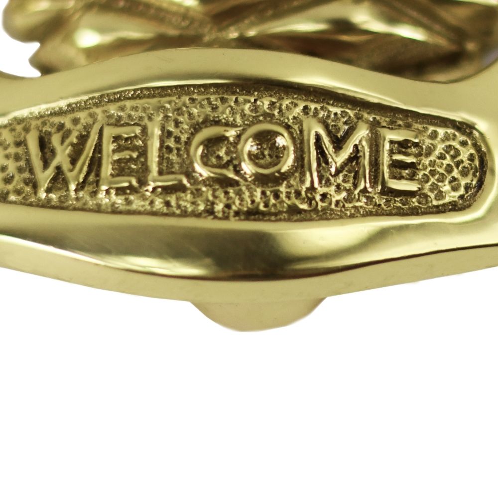 Welcome text on the polished brass pineapple door knocker