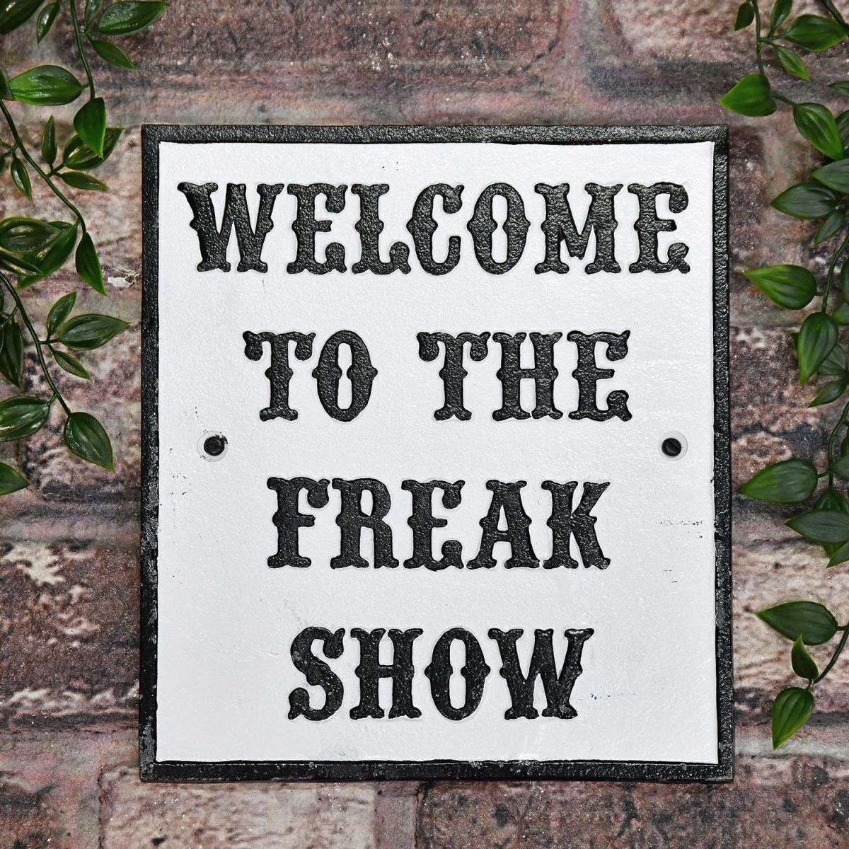 "Welcome To The Freak Show" Cast Iron Sign on a Brick wall Outside
