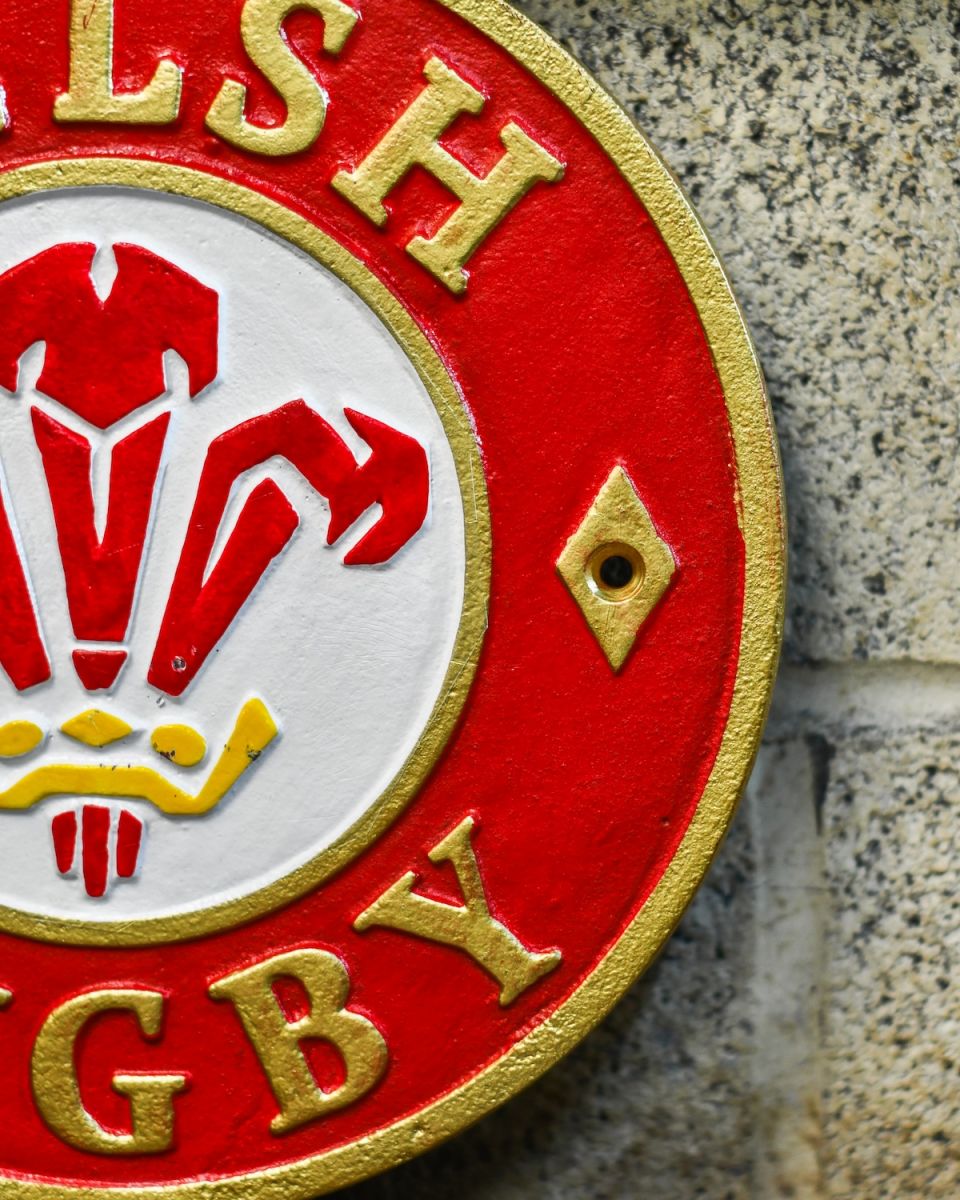 Close up of hand painted detail on cast iron rugby wall sign Close up of hand painted detail on cast iron rugby wall sign
