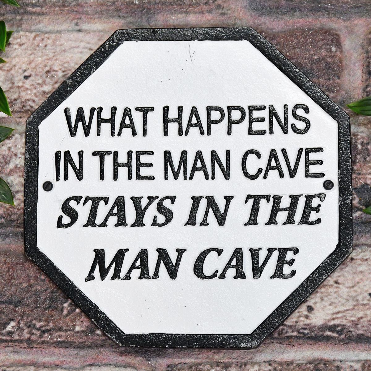 "What Happens In The Man Cave Stays In The Man Cave" Cast Iron Sign on a Brick wall Outside