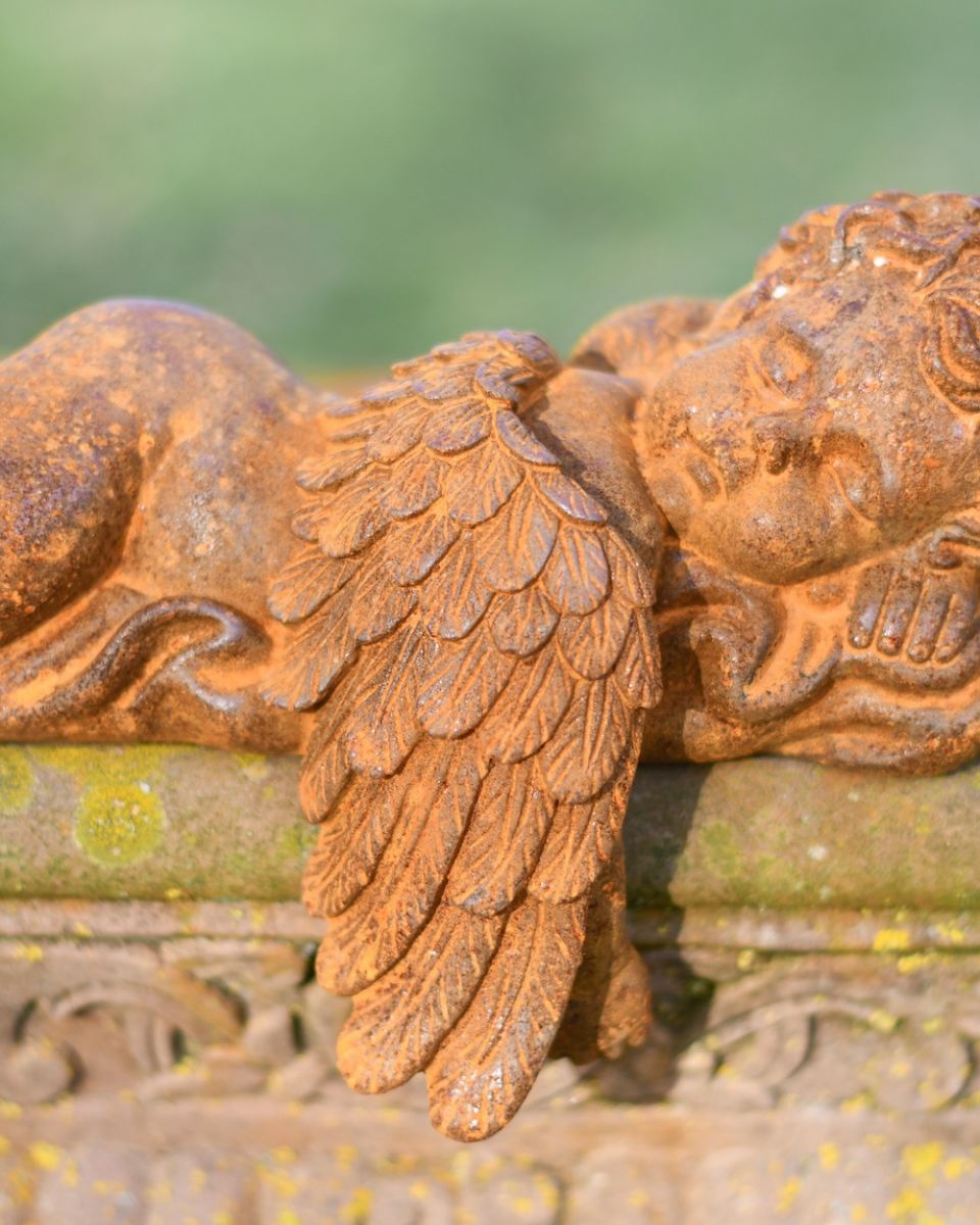 Close up of wing detail on rustic finish cast iron statue