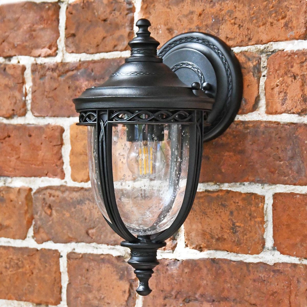 "Winsford" Traditional Top Fix Black Wall Lantern in Situ on a Brick Wall