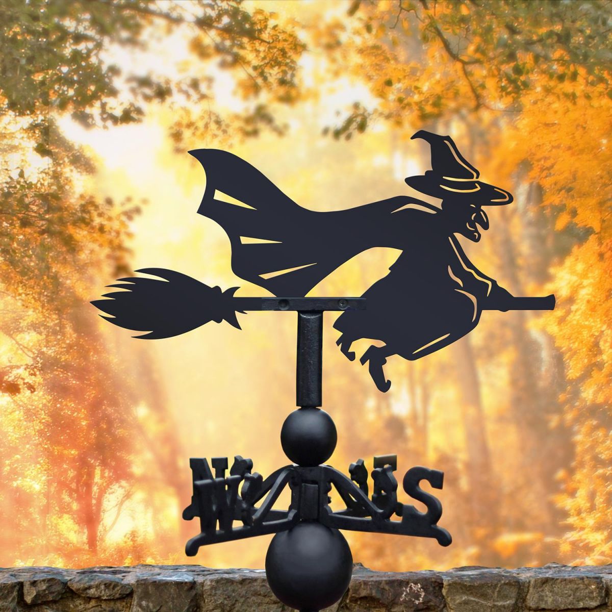 Witch Riding Broom Weathervane in Use in by Autumn Coloured Trees