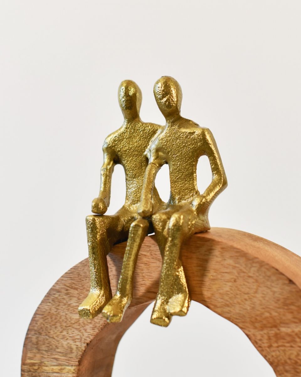 Close up of cast aluminium gold figures on home decor sculpture Close up of cast aluminium gold figures on home decor sculpture