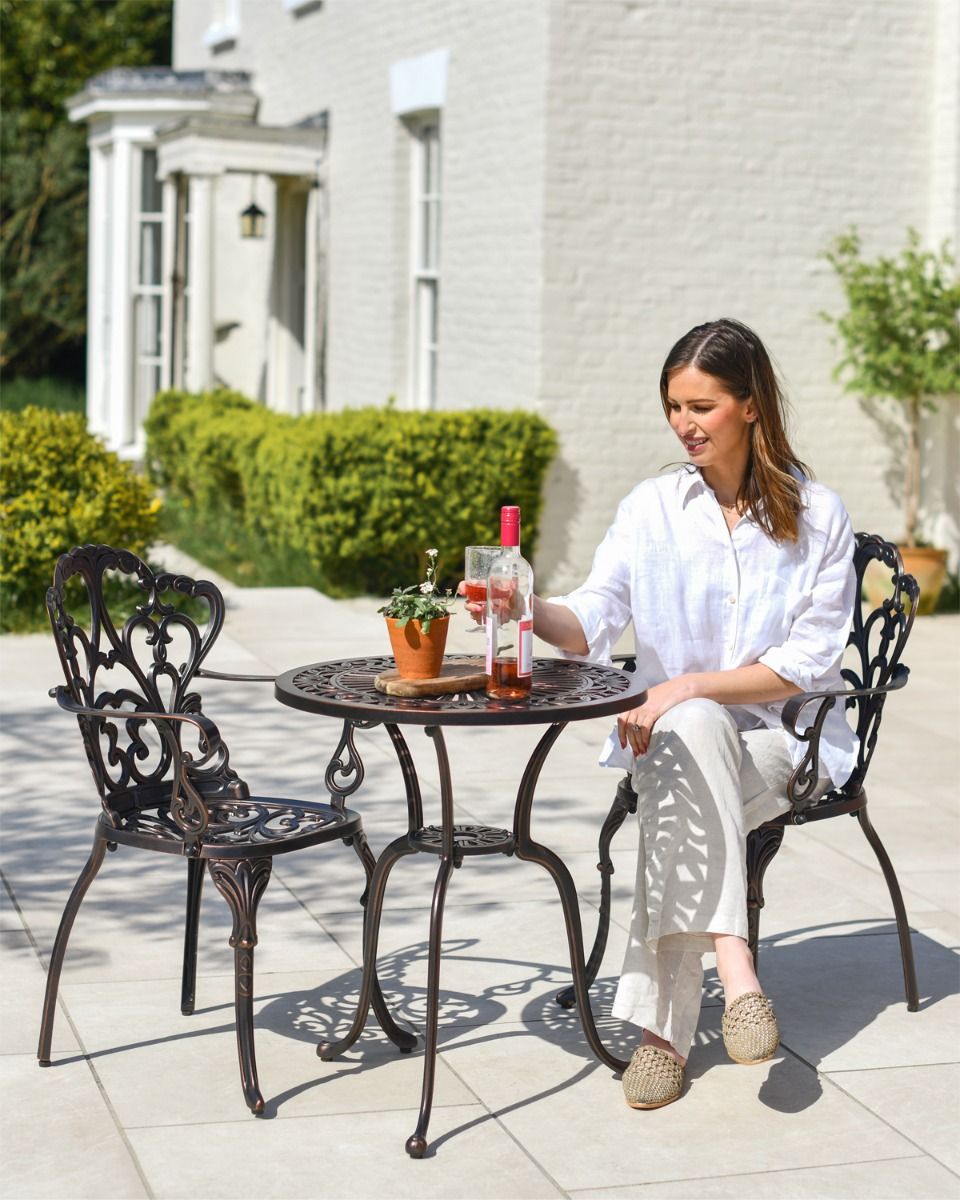 Woman Sat at Copper Garden Furniture Woman Sat at Copper Garden Furniture