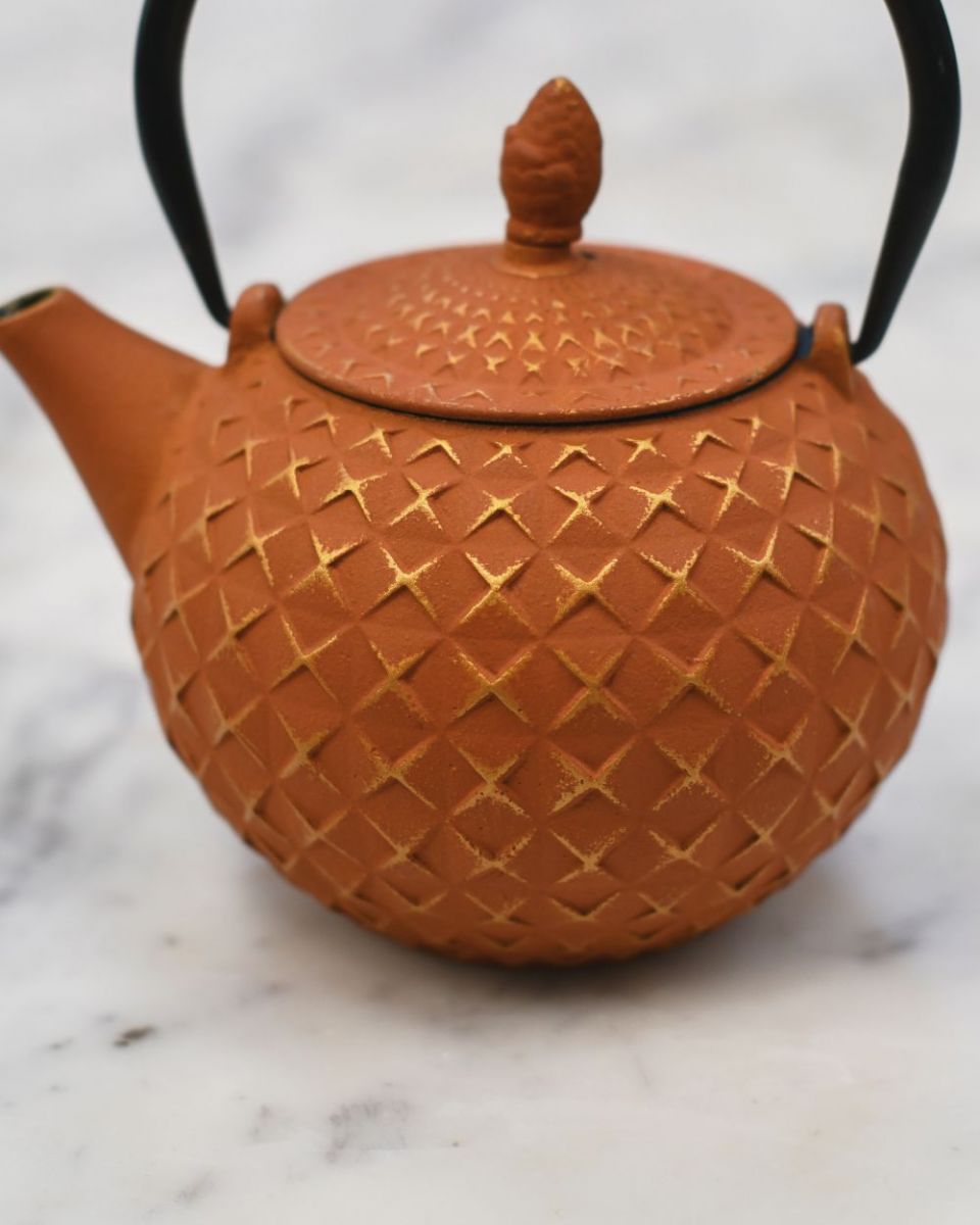 Close up of "Xinbei" Cast Iron Orange Japanese Style Teapot embossed detailing Close up of "Xinbei" Cast Iron Orange Japanese Style Teapot embossed detailing