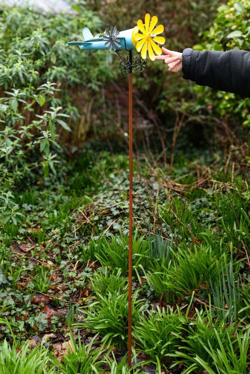 Vintage Airplane Wind Spinner Stakes in Blue and Yellow with Hand in Shot for Scale