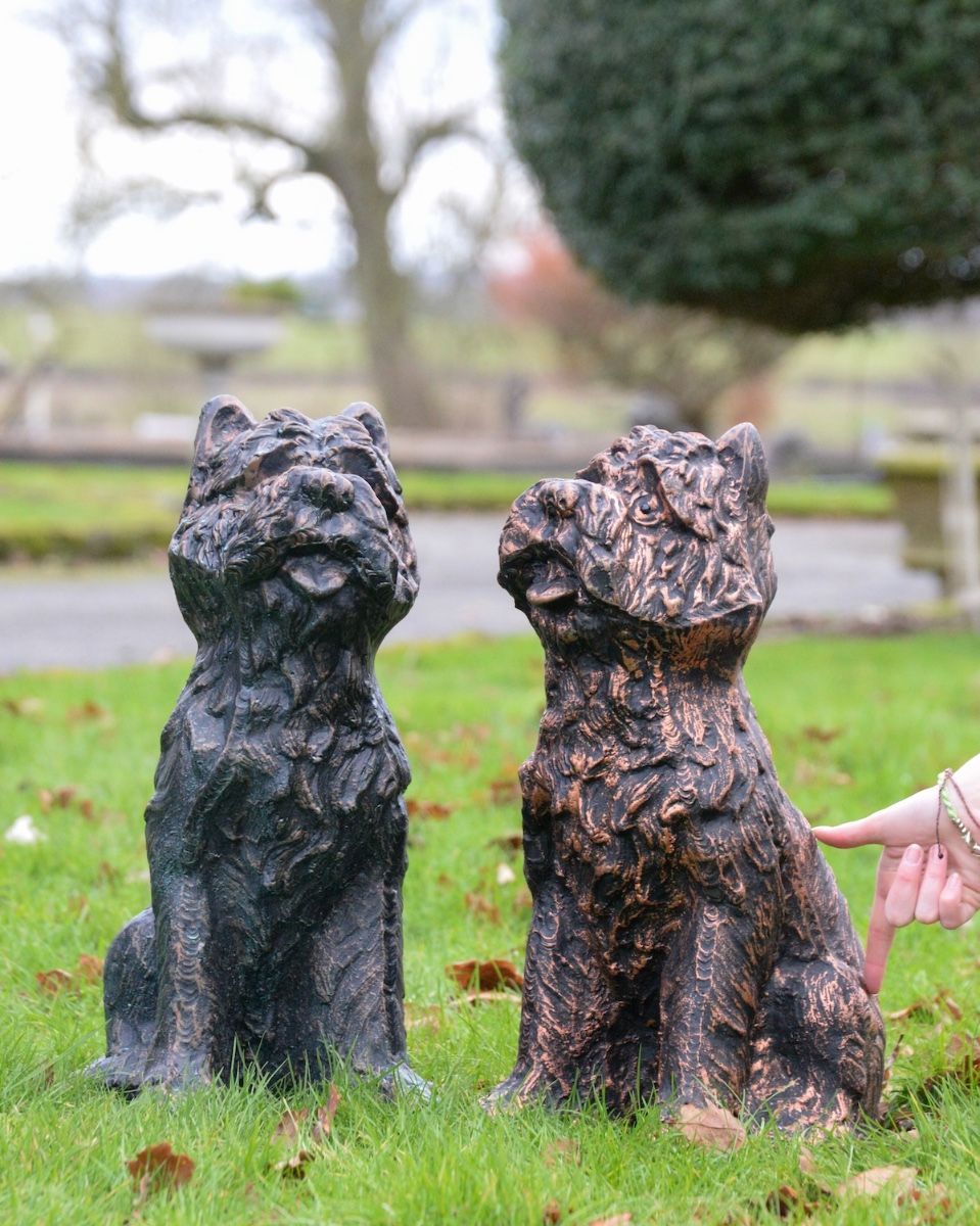 ‘Baxter’ the Yorkshire Terrier Garden Sculpture in Cast Aluminium - Copper with hand for scale reference stood next to verdigris version