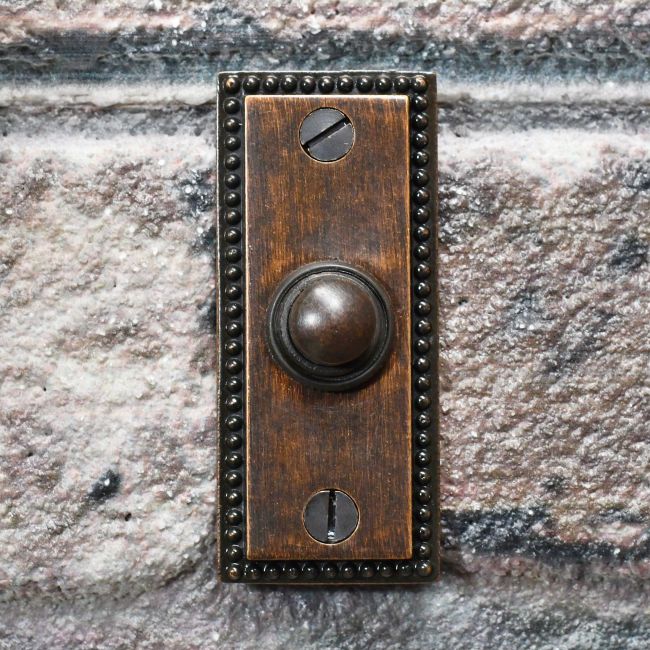 Burnished Copper Georgian Bell Push on brick wall Burnished Copper Georgian Bell Push on brick wall