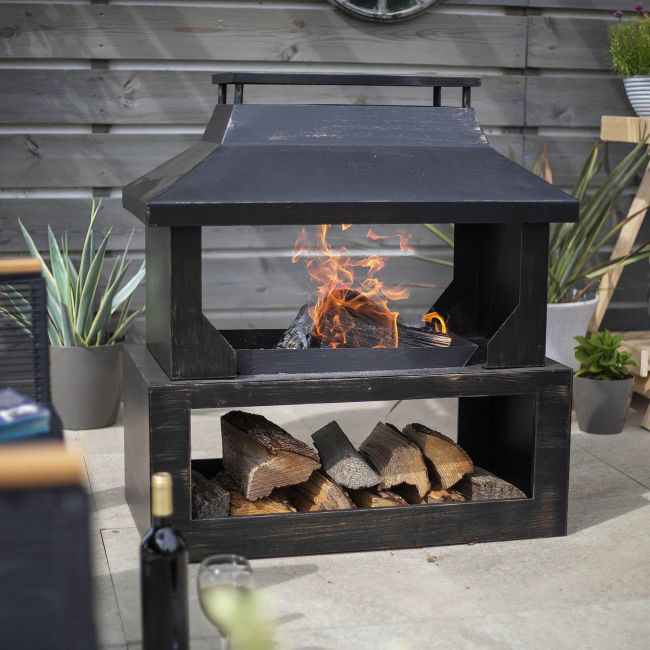 Large Wood Burner and Log Store in Use in the Garden Large Wood Burner and Log Store in Use in the Garden