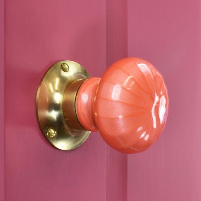 "Sunrise Orange" Hand Finished Ceramic Door Knob on a Pink Door "Sunrise Orange" Hand Finished Ceramic Door Knob on a Pink Door
