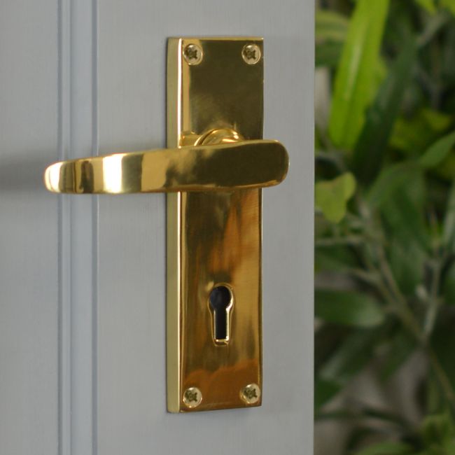 Polished Brass Lever Handle With Key Hole on Grey Door Polished Brass Lever Handle With Key Hole on Grey Door