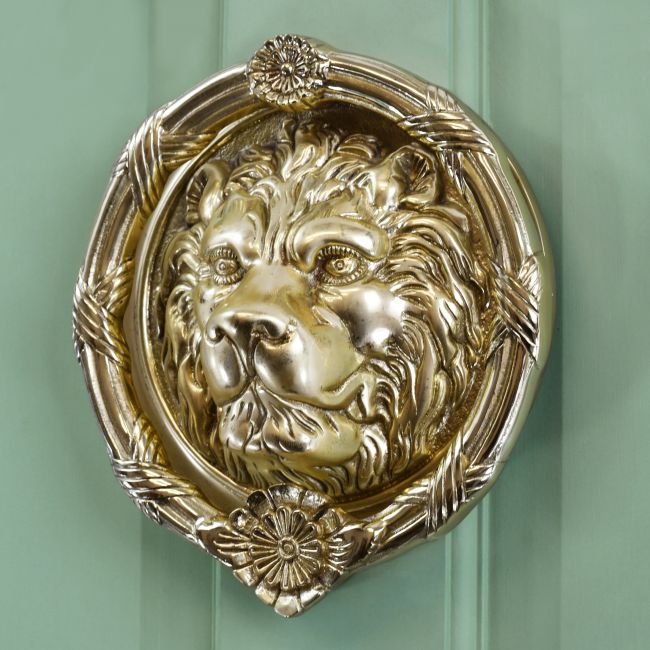 Large Sandringham lion door knocker on Green door Large Sandringham lion door knocker on Green door