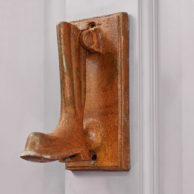 Wellington boot shaped door knocker on grey door Wellington boot shaped door knocker on grey door