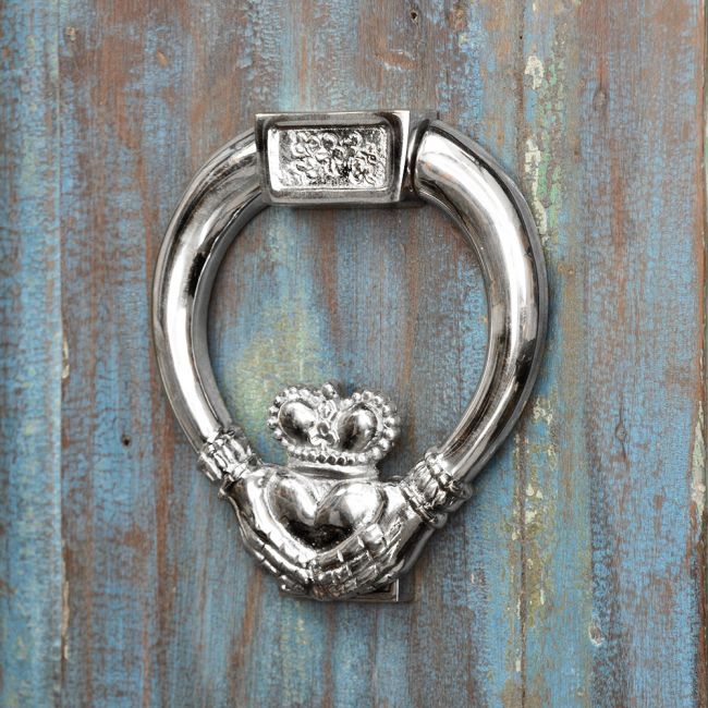 bright Chrome Claddagh Door Knocker on rustic door bright Chrome Claddagh Door Knocker on rustic door