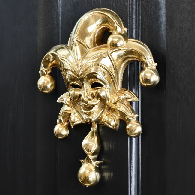 Polished Brass Jester Door Knocker on Black door Polished Brass Jester Door Knocker on Black door