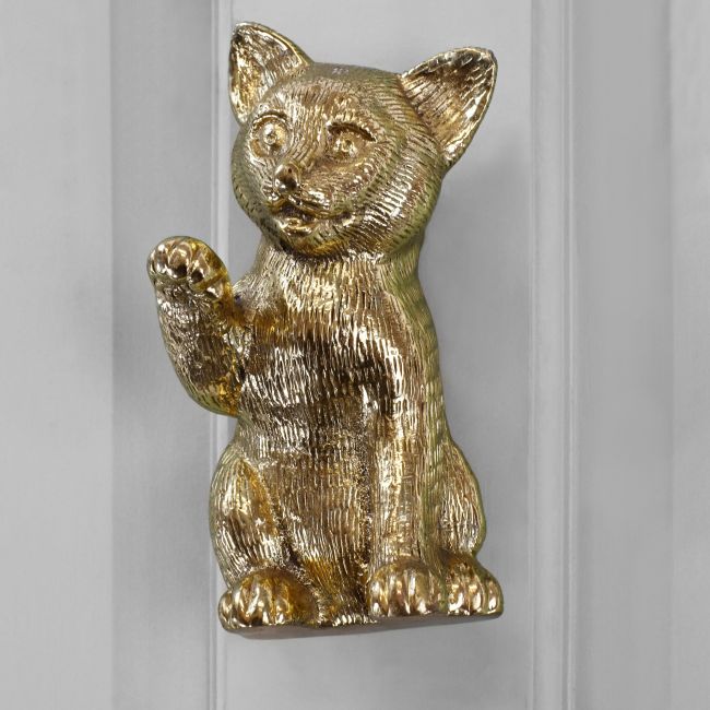 Polished brass Cat door knocker on grey door Polished brass Cat door knocker on grey door