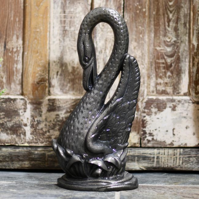 Swan Door Porter in Situ Holding Open a Rustic Wooden Door Swan Door Porter in Situ Holding Open a Rustic Wooden Door