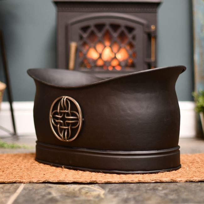 Celtic coal or log bucket infront of fire Celtic coal or log bucket infront of fire