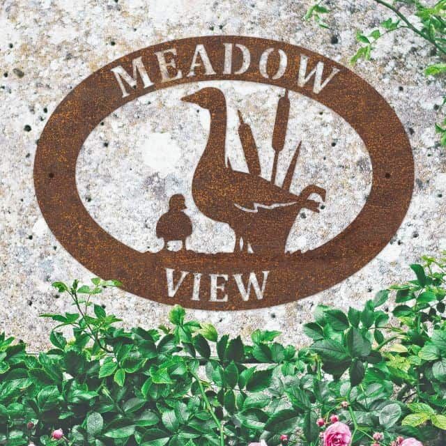 Goose & Gosling Iron Oval House Sign in situ in a Stone Wall