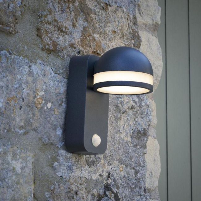 Matt Grey Adjustable LED Wall Light with PIR Sensor in Situ on a Stone Wall Matt Grey Adjustable LED Wall Light with PIR Sensor in Situ on a Stone Wall