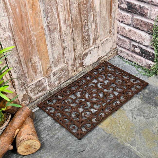 Black Rectangular Cast Iron Door Mat with an Ornate Design Black Rectangular Cast Iron Door Mat with an Ornate Design