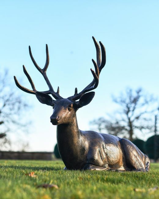 Recycled Cast Aluminium Brushed Bronze "Tranquil Glen" Lying Stag Sculpture in Situ