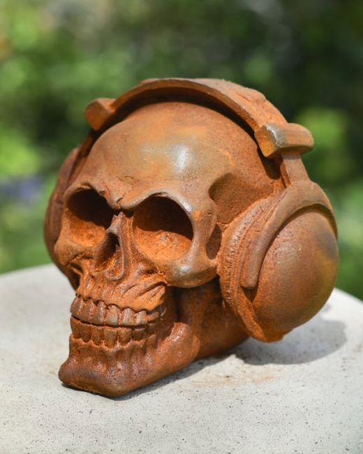 Rusted Skull wearing Headphones Garden Ornament