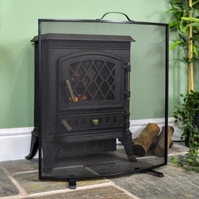 “Rowscroft” Black Curved Custom Fire Screen in Situ Next to a Green Wall “Rowscroft” Black Curved Custom Fire Screen in Situ Next to a Green Wall