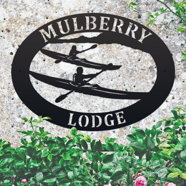 Kayaking Iron Oval House Sign in situ in a Stone Wall