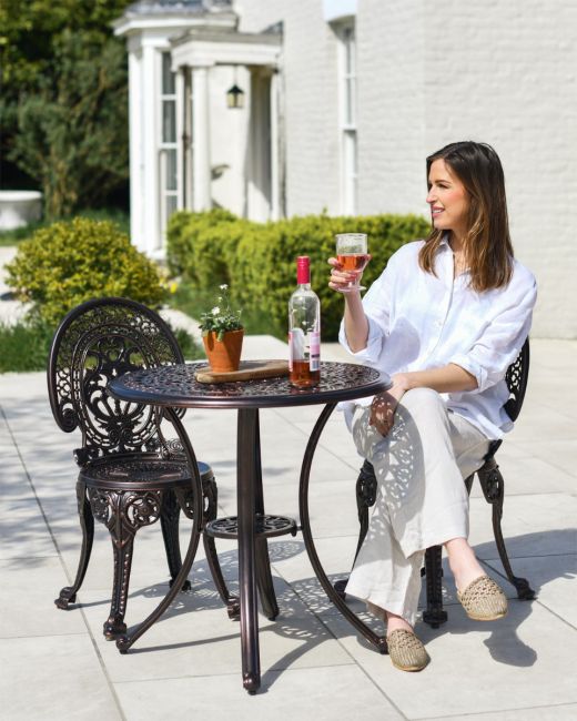 Woman Sat at Two Seater Garden Furniture Woman Sat at Two Seater Garden Furniture