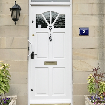 Black Iron Musical Note door knocker white door